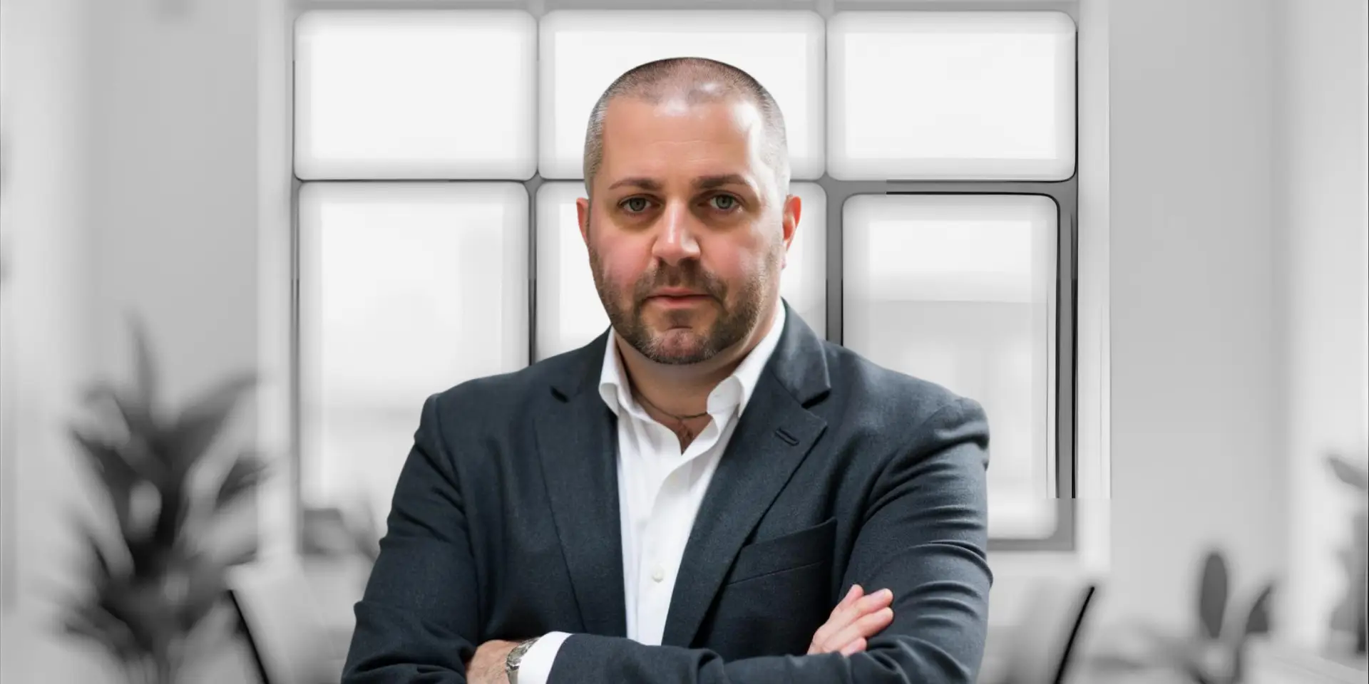 Kain Ramsay is standing in the Achology marketing team's head offices, representing his professional and approachable demeanour during 1-1 meetings, mentorship, or consultations.