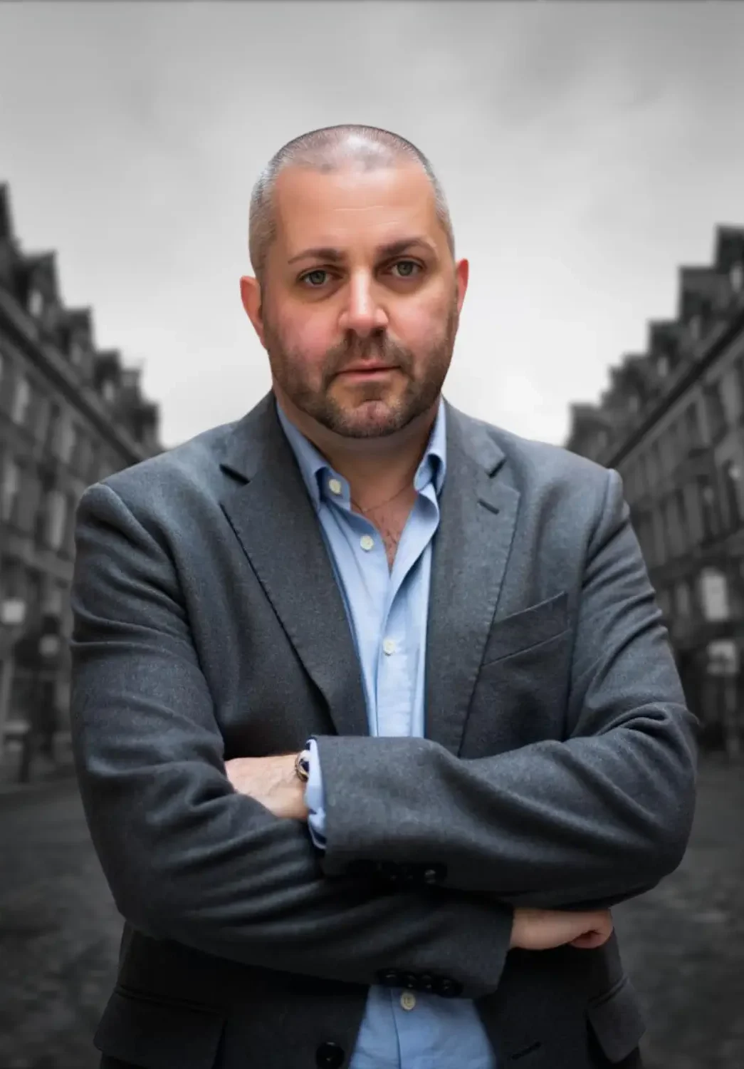 Kain Ramsay smiling and standing on the Royal Mile in Edinburgh, representing his professional and approachable demeanour during 1-1 meetings, mentorship, or consultations.